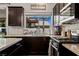 Open concept kitchen with stainless steel appliances and view to the backyard at 2199 Maple Shade St, Henderson, NV 89002