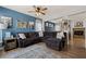 Comfortable living room with a large sectional sofa, a ceiling fan, and an opening to the dining area at 2199 Maple Shade St, Henderson, NV 89002