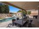 Backyard features a sparkling pool, dining area, shed, and low-maintenance turf at 2199 Maple Shade St, Henderson, NV 89002