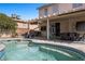 Backyard pool area with a built-in seating, an outdoor kitchen, and a covered patio at 2199 Maple Shade St, Henderson, NV 89002