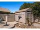 Backyard shed with mounted hose rack, neutral paint, and trim at 2199 Maple Shade St, Henderson, NV 89002