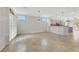 Bright living room with tile floors and natural light, adjacent to the kitchen with a breakfast bar at 2365 Orangeburg Pl, Henderson, NV 89044