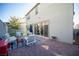 Beautiful backyard featuring a brick-paved patio, lush artificial turf, and modern outdoor furniture at 2514 Spergola St, Henderson, NV 89044