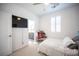 Bright bedroom with a TV, ceiling fan, plush carpet, and a convenient en suite bathroom at 2514 Spergola St, Henderson, NV 89044