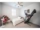Well-lit bedroom featuring a single bed, exercise equipment, and a window at 2514 Spergola St, Henderson, NV 89044