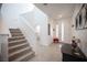 Modern entryway with staircase, herringbone floors, decorative art and console table at 2514 Spergola St, Henderson, NV 89044