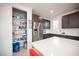 Kitchen featuring white countertops, stainless steel fridge, and pantry with ample storage at 2514 Spergola St, Henderson, NV 89044