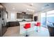 Modern kitchen with stainless steel appliances, large island, and sliding doors to outdoor space at 2514 Spergola St, Henderson, NV 89044