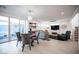 Bright living room with herringbone floors, chandelier, and sliding door access to the patio at 2514 Spergola St, Henderson, NV 89044