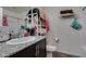 Bathroom featuring a dark vanity, granite countertop, toilet, and bath/shower with white tile at 2598 Mocha Pearl Ct, North Las Vegas, NV 89086