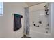 Bright bathroom featuring a tub shower with a blue patterned curtain and wall mounted towel racks at 2598 Mocha Pearl Ct, North Las Vegas, NV 89086