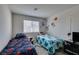 Bedroom featuring two beds, a window, and playful decor at 2598 Mocha Pearl Ct, North Las Vegas, NV 89086