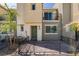 Charming townhome featuring a cozy front patio with iron fencing and desert landscaping at 2598 Mocha Pearl Ct, North Las Vegas, NV 89086