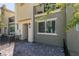 Townhome showcasing a cozy front patio with pavers and iron fencing with drought resistant landscaping at 2598 Mocha Pearl Ct, North Las Vegas, NV 89086
