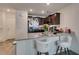 Kitchen area featuring granite countertop, dark cabinets, and modern seating at 2598 Mocha Pearl Ct, North Las Vegas, NV 89086