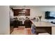 A kitchen with stainless steel appliances, granite countertops, and an adjacent living area at 2598 Mocha Pearl Ct, North Las Vegas, NV 89086