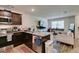 Modern kitchen with granite countertops and stainless steel appliances, connecting to living area at 2598 Mocha Pearl Ct, North Las Vegas, NV 89086