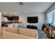 Well-lit living area showcasing a comfortable couch, a kitchen view, and hardwood floors at 2598 Mocha Pearl Ct, North Las Vegas, NV 89086