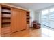 A bedroom featuring hardwood floors, built in wardrobe, shelving and a leather chair at 2747 Paradise Rd # 1706, Las Vegas, NV 89109