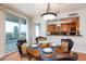 Chic dining area with a round wood table, city views, and a glimpse into the modern kitchen with stainless steel appliances at 2747 Paradise Rd # 1706, Las Vegas, NV 89109