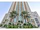 Elegant high-rise exterior showcasing lush landscaping with palm trees and a grand entrance, under a clear blue sky at 2747 Paradise Rd # 1706, Las Vegas, NV 89109
