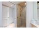 A glass-enclosed shower features tile and a gold shower head and handle at 2747 Paradise Rd # 1706, Las Vegas, NV 89109