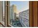 A window with a view of buildings, tennis courts, trees, and city life at 2747 Paradise Rd # 1706, Las Vegas, NV 89109