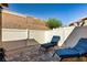Relaxing back patio with brick pavers, privacy fence, and two blue lounge chairs at 2773 Chetco River St, Laughlin, NV 89029