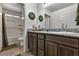 Well-lit bathroom with wood cabinets, granite countertop, and shower-tub combination at 2773 Chetco River St, Laughlin, NV 89029