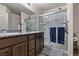 Modern bathroom with granite countertop, double sinks, and glass enclosed shower at 2773 Chetco River St, Laughlin, NV 89029
