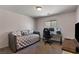 Cozy bedroom features a daybed, desk, and natural light from the window at 2773 Chetco River St, Laughlin, NV 89029