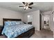 Bright bedroom featuring ceiling fan, a queen bed and neutral colored carpet at 2773 Chetco River St, Laughlin, NV 89029