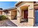 Inviting front entrance of a well-maintained home with a brick walkway and covered porch with red door at 2773 Chetco River St, Laughlin, NV 89029