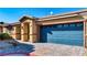 Inviting single-story home with a well-maintained brick driveway and a blue garage door at 2773 Chetco River St, Laughlin, NV 89029