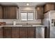 This kitchen features stainless steel appliances, granite countertops, and wood cabinets at 2773 Chetco River St, Laughlin, NV 89029