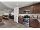 Open-concept kitchen flowing into the living room, featuring granite counters and modern appliances at 2773 Chetco River St, Laughlin, NV 89029