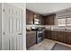 Modern kitchen featuring dark wood cabinets, stainless steel appliances, and granite countertops at 2773 Chetco River St, Laughlin, NV 89029