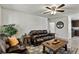 Inviting living room with a comfortable sofa, ceiling fan, and an open layout connecting to the kitchen at 2773 Chetco River St, Laughlin, NV 89029