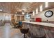 Basement bar area with wood details, retro appliances, gaming table, and stairs at 306 Crestview Dr, Las Vegas, NV 89124