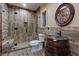 Rustic bathroom featuring custom sink, walk-in shower, and decorative mirror at 306 Crestview Dr, Las Vegas, NV 89124