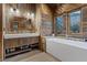 Modern bathroom with a wood vanity, soaking tub and mountain views at 306 Crestview Dr, Las Vegas, NV 89124