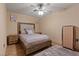 Cozy bedroom features a wood-framed bed, ceiling fan, and stylish furnishings at 306 Crestview Dr, Las Vegas, NV 89124