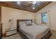 Inviting bedroom featuring a comfortable bed, side tables, and a serene window view at 306 Crestview Dr, Las Vegas, NV 89124