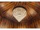 Close up of a chandelier with natural wood finishes and picturesque views from multiple windows at 306 Crestview Dr, Las Vegas, NV 89124