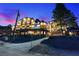 Mountain home at dusk with beautiful balconies, large windows, and inviting lighting at 306 Crestview Dr, Las Vegas, NV 89124