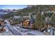 Mountain home on a hillside community road surrounded by forestry and other homes at 306 Crestview Dr, Las Vegas, NV 89124
