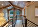 Hallway showcasing wood beam ceilings, mountain views through the large windows, and stylish railing at 306 Crestview Dr, Las Vegas, NV 89124