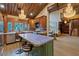 Spacious kitchen with an island, wooden cabinets, stainless steel appliances, and an adjacent living area at 306 Crestview Dr, Las Vegas, NV 89124