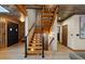 Unique home entryway with wooden staircase, paneling, chandelier and double doors at 306 Crestview Dr, Las Vegas, NV 89124