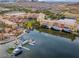 Aerial view of lakeside buildings with marina, offering waterfront living and picturesque community amenities at 33 Via Di Mello, Henderson, NV 89011